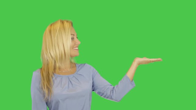 Woman showing and presenting empty hand smiling joyful. Pretty young Caucasian female model isolated on transparent background in studio.