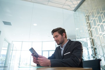 Fototapeta premium Businessman using digital tablet at desk