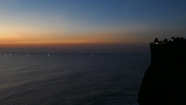 Ocean swells at Uluwatu, landmark cliff-top temple at sunset