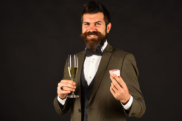 Macho in retro suit presents little pink box holding drink