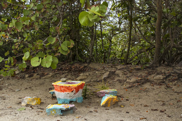 A grinding table with indentation and stone grinder made out of brightly painted pieces of concrete...