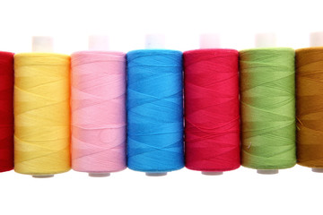 A colorful spool with threads often used in tailoring and is an indispensable element of this profession.

