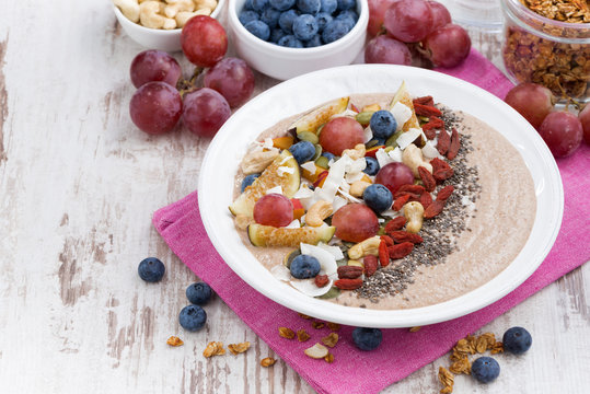 oatmeal with assorted fruits, nuts and chia