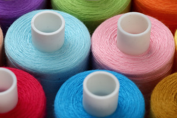 A colorful spool with threads often used in tailoring and is an indispensable element of this profession.
