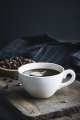 Coffee cup on wooden board