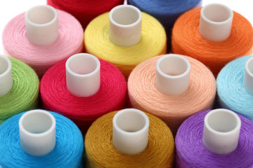 A colorful spool with threads often used in tailoring and is an indispensable element of this profession.
