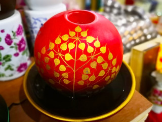 The perfume box, it made from red plastic and draw the pattern of golden leaves, used to make fresh air.