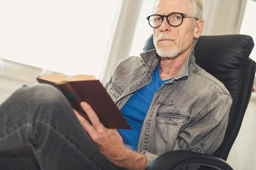 Portrait of mature man reading a book