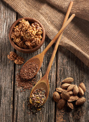 Food ingredients in wooden spoon on wooden background.