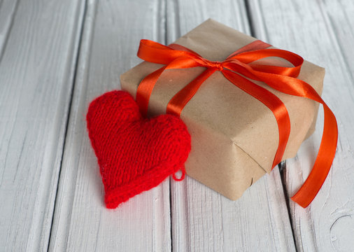 red heart and gift on wooden background