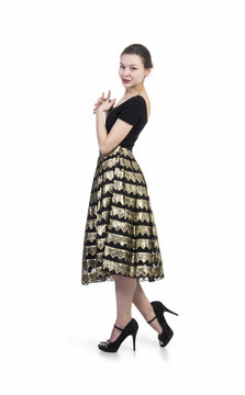 The girl in the wide, Golden skirt and tight black blouse.