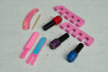 A collection of accessories needed for a manicure or pedigree isolated on plain background