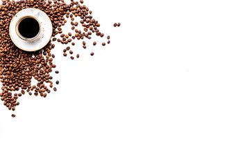 Cup of freshly brewed full-bodied coffee on white table top view copyspace. Coffee background.