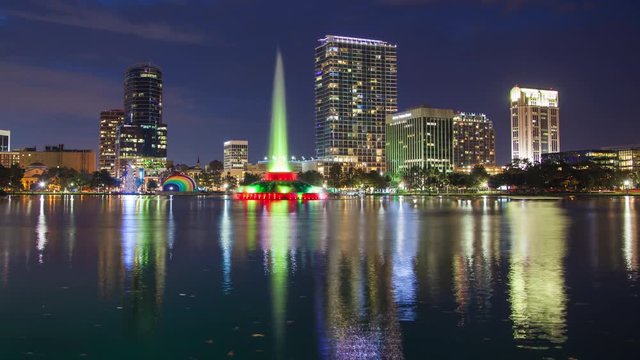 Orlando FL City Skyline Evening Timelapse over Lake Eola Park featuring the Fountain and Building Lights Reflecting onto the Water at Dusk