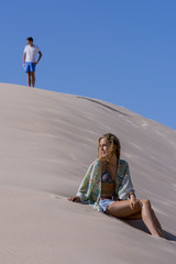 A young girl and boy, on some natural dunes