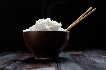 hot rice in brown bowl with chopsticks in japanese style