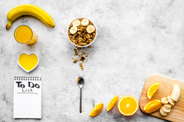Start the day the right way. Healthy breakfast oatmeal with fruits and planning the day. Grey background top view copyspace