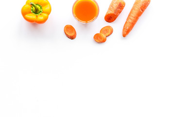 Wellness elements. Orange detox drinks with paprica and carrot on white background top view copyspace