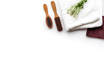 Women hair care set. Combs and shampoo on white background top view copyspace