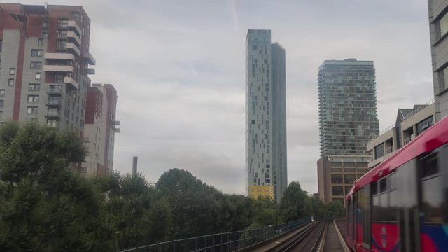 canary wharf in london, POV shot from the moving docklands light railway.