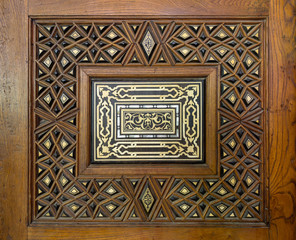 Closeup of arabesque ornaments of an old aged decorated wooden door, Old Cairo, Egypt