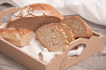 Sliced loaf of bread in a wooden bread box