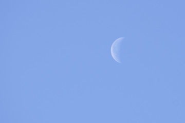 Obraz na płótnie Canvas moon in a clear sky under a bright sun