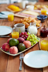 fruits, juice and other food on table at breakfast