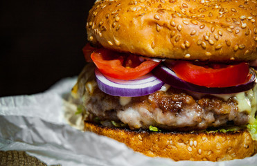 burger on wooden table. on dark background with copy space.