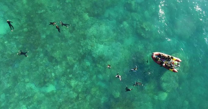 WHITSUNDAY ISLANDS &ndash; FEBRUARY 2016 : Aerial shot over divers near Whitehaven Beach on a beautiful day with motorboat in view