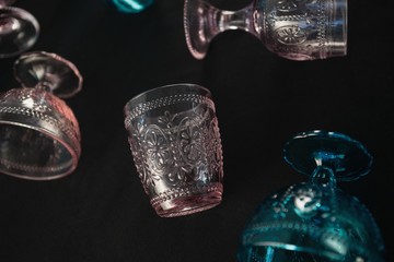 Colored glass and cups against a black background