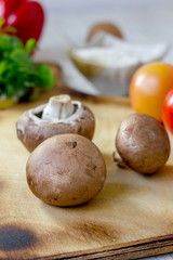 Fototapeta na wymiar Portobello champignon on a kitchen wooden table