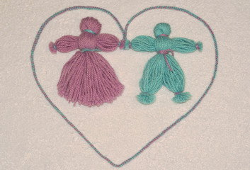 Dolls of yarn on a background of towel