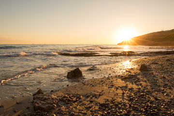 The calm sea in a very cloudy sunset