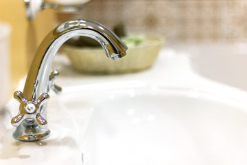Water tap faucet in a classic bathroom.
