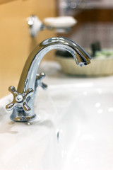Water tap faucet in a classic bathroom.