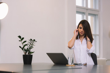 Girl sitting in office and listening to the music.