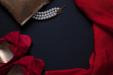 a string of pearls on a black background, burning lights, a red box. St. Valentine's Day