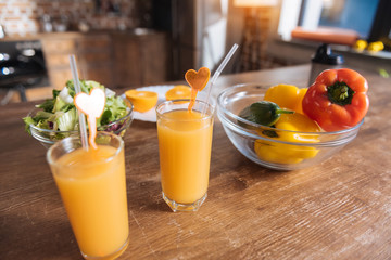 Fresh drink. Close up of glasses with fresh orange juice standing on the table
