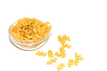 Dried raw, uncooked spirelli pasta noodles backlit in glass container isolated on white background.