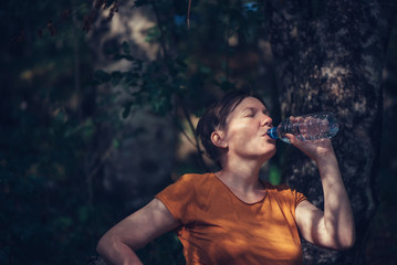 Woman drinking water outdoors