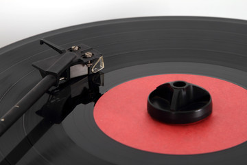 Pickup on a vinyl LP. Focus on the pickup head. © kosanperm