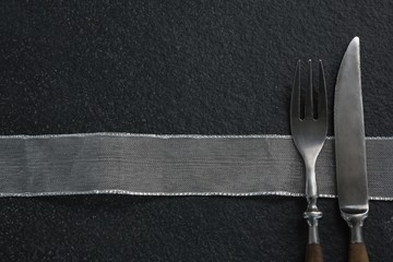 Fork and butter knife with a cloth - Powered by Adobe