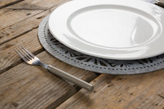 Plate with fork on wooden table