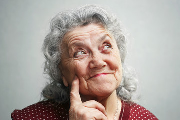 Smile and thinking old woman face