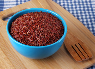 Red rice in the blue bowl.