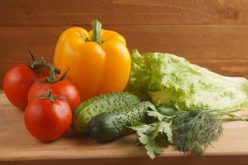 Fresh vegetables for salad. Greens, tomatoes, cucumbers