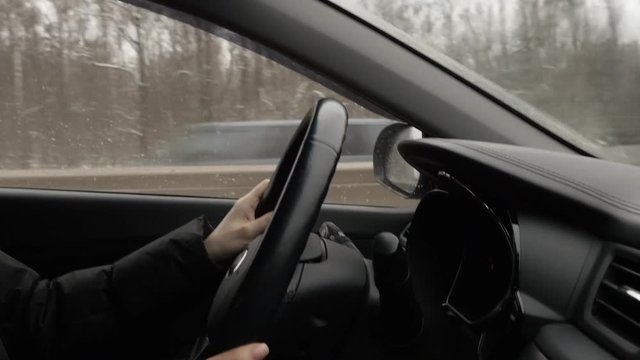 Woman With Steering Whell Driving In Winter Day
