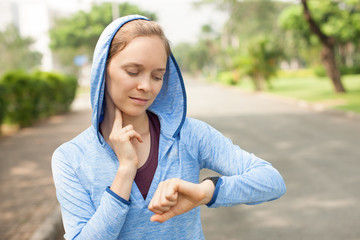 Content Sporty Woman Taking Pulse Outdoors