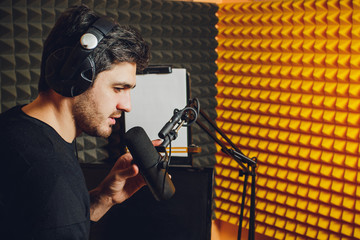 Microphone in radio studio and presenter on background